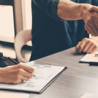 close up. financial partners shaking hands over the Desk. business concept.